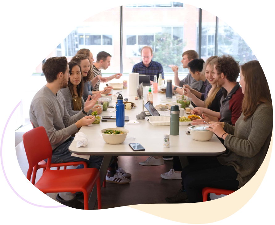 Photo of Ginger Labs employees having lunch at the office lunch table